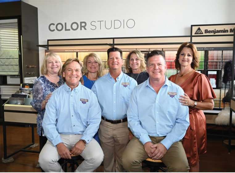 A group photo of the dealership staff in the store showroom